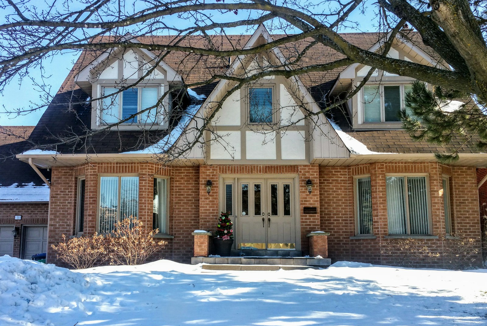 brown and white concrete house near bare trees during daytime, home